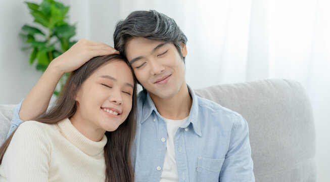 Asian couple smile and happy hug each other's eyes, cuddling, warm hugs, teenager's first love, married couple, warm family. Husband and wife in love so fun in new years eve or valentine day