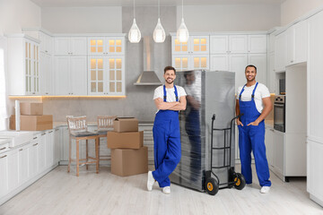 Male movers with refrigerator in new house