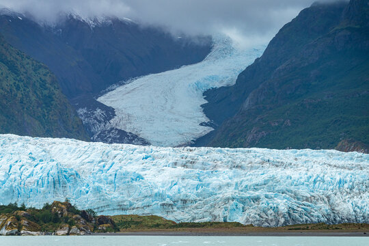 Milky light blue ocean by Amalia glacier with detail of the fissures and rocks in its path