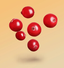 Delicious ripe cranberries falling on color background