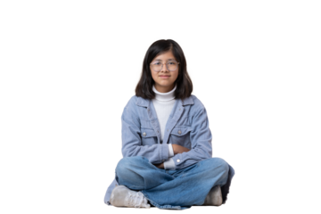 Mexican 12 year old girl sitting on the floor looking at camera