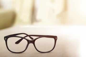 Vintage stylish black eyeglasses on desk