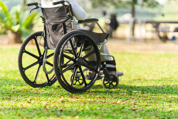 Fototapeta premium Happy asian elderly woman sitting on wheelchair outdoor in park relax your mind with green nature.