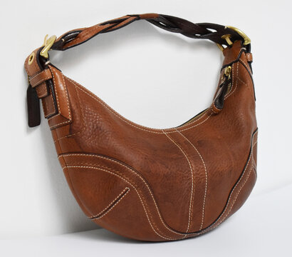 90s vintage brown leather hobo bag isolated on white