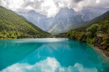 Green, turquoise lake water in Blue Moon Valley, Yunnan, China in the summer. Stunning mountain...