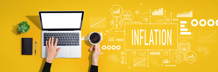 Inflation theme with person using a laptop computer