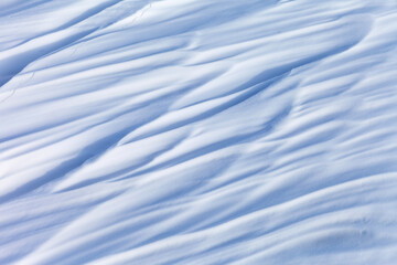 Abstract snow natural winter texture of snowy crust on ice of frozen Baikal Lake in cold day. White...