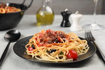 Delicious pasta with meatballs and tomato sauce served on table, closeup