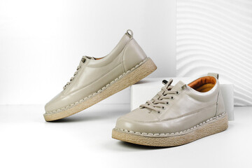 Beige Trendy Sneakers. Fashion shoes still life. Stylish photo boots in the studio.  casual shoes, fashion, footwear, shoe concept, retro, back to school. 