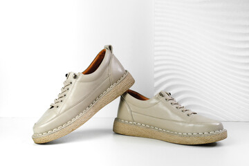 Beige Trendy Sneakers. Fashion shoes still life. Stylish photo boots in the studio.  casual shoes, fashion, footwear, shoe concept, retro, back to school. 