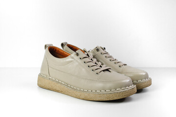 Beige Trendy Sneakers. Fashion shoes still life. Stylish photo boots in the studio.  casual shoes, fashion, footwear, shoe concept, retro, back to school. 
