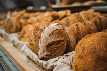 Shot of several crusty handmade breads displayed in a bakery