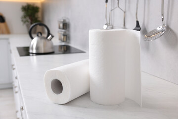 Rolls of paper towels on white countertop in kitchen