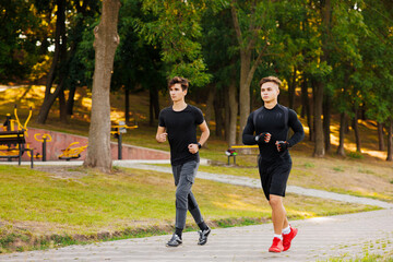 Obraz premium Friends fitness training together outdoors in the morning in park living active healthy. Healthy lifestyle concept.