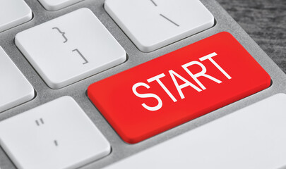 Red button with word Start on computer keyboard, closeup