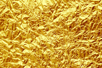 Crumpled golden foil as background, closeup view