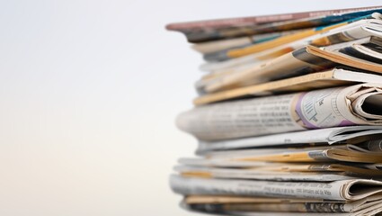 A pile of dusty, old magazines on background