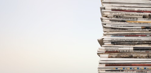 A pile of dusty, old magazines on background