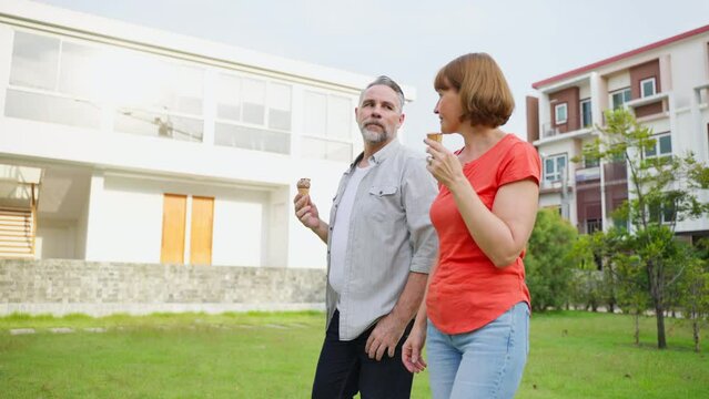 Caucasian senior man and woman having a picnic outdoors in the garden.