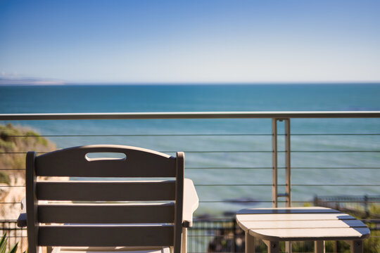Chair and Table Overlooking the Calm and Serene Pacific Ocean Landscape