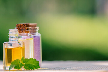 bottles of oils and massage and spa salts on a natural background