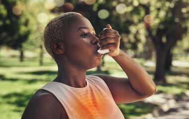 Nature, fitness and woman with asthma pump after an intense running workout or training in park....