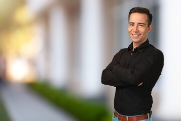 Young businessman with arms crossed posing