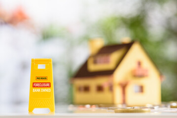 Foreclosures and foreclosed home for sale property listings, financial concept : Yellow warning...