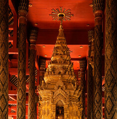 Golden Buddhist statues and carving showing intricate details and textures created by Buddhist...