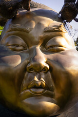 Golden Buddhist statues and carving showing intricate details and textures created by Buddhist...