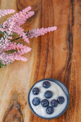 blueberries with yogurt on a black plate