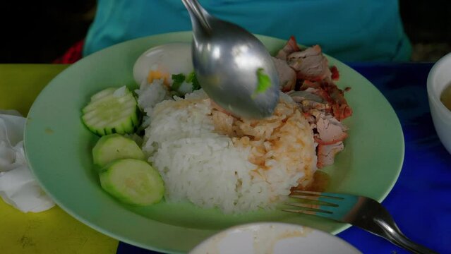Khao man gai boiled chicken lunch meal with veggies