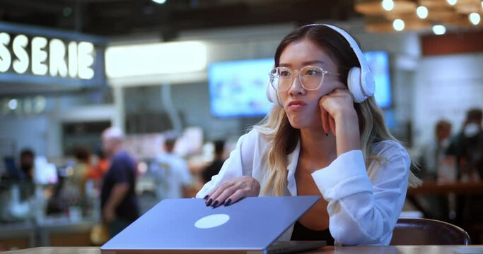 Sad asian young woman freelancer dissatisfied with the result of working at laptop computer, remotely in cafe. Young asian business woman freelancer closes laptop disappointed with the failure in work