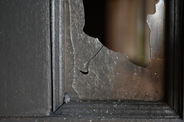 burn dirty black wood door with broken glass texture background