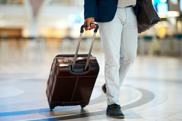 Airport, suitcase and black man travel for business opportunity, international career and immigration. Professional person or entrepreneur legs walking with luggage for flight, wealth and global job