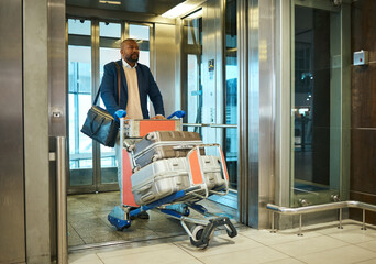 Black man, travel for business and luggage with airport and conference, exit elevator with suitcase...