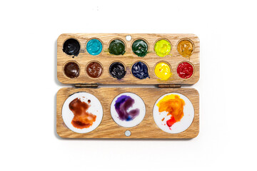 Wooden watercolor palette. Watercolor tray with watercolor set isolated on a white background.