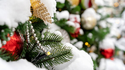 Decorated Christmas tree. Close-up of branches and decorative elements. Christmas green background.