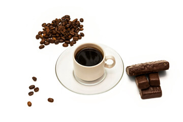Grains of coffee, a cup of coffee and chocolate sweets