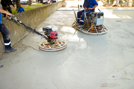 Two types of power trowel with engine, machine for finishing, leveling concrete surface