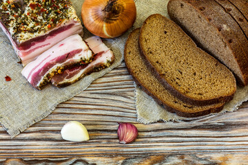 Salted farm lard with bread, onions and garlic