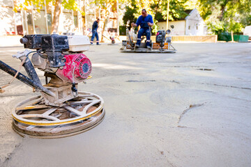 Two types of power trowel with engine, machine for finishing, leveling concrete surface