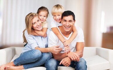 Fototapeta na wymiar Happy young family with children on a sofa