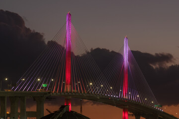 New Gerald Desmond Bridge, looking west, shown at dusk in the Port of Long Beach, California. The red, pink, and white color scheme is chosen to celebrates St Valentine's Day.
