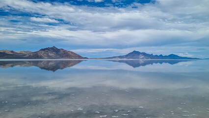 Panoramic view of beautiful mountain reflecting in lake of Bonneville Salt Flats, Wendover, Western Utah, USA, America. Looking at summits of Silver Island Mountains range. West of Great Salt Lake