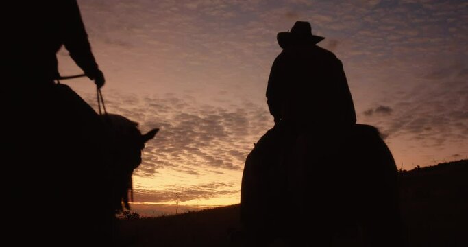 Four Cowboys Riding into the Dawning Sun Silhouette.
