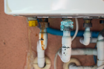 Rusty pipe on a gas boiler close-up.