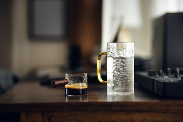 Fototapeta na wymiar Iced americano coffee in glass on work table at home