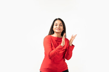 Happy attractive Indian woman laughing and smiling, applauding, clap hands and looking joyful