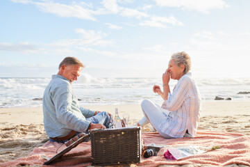 Senior couple, romantic beach picnic and smile together in summer for conversation, memory and...